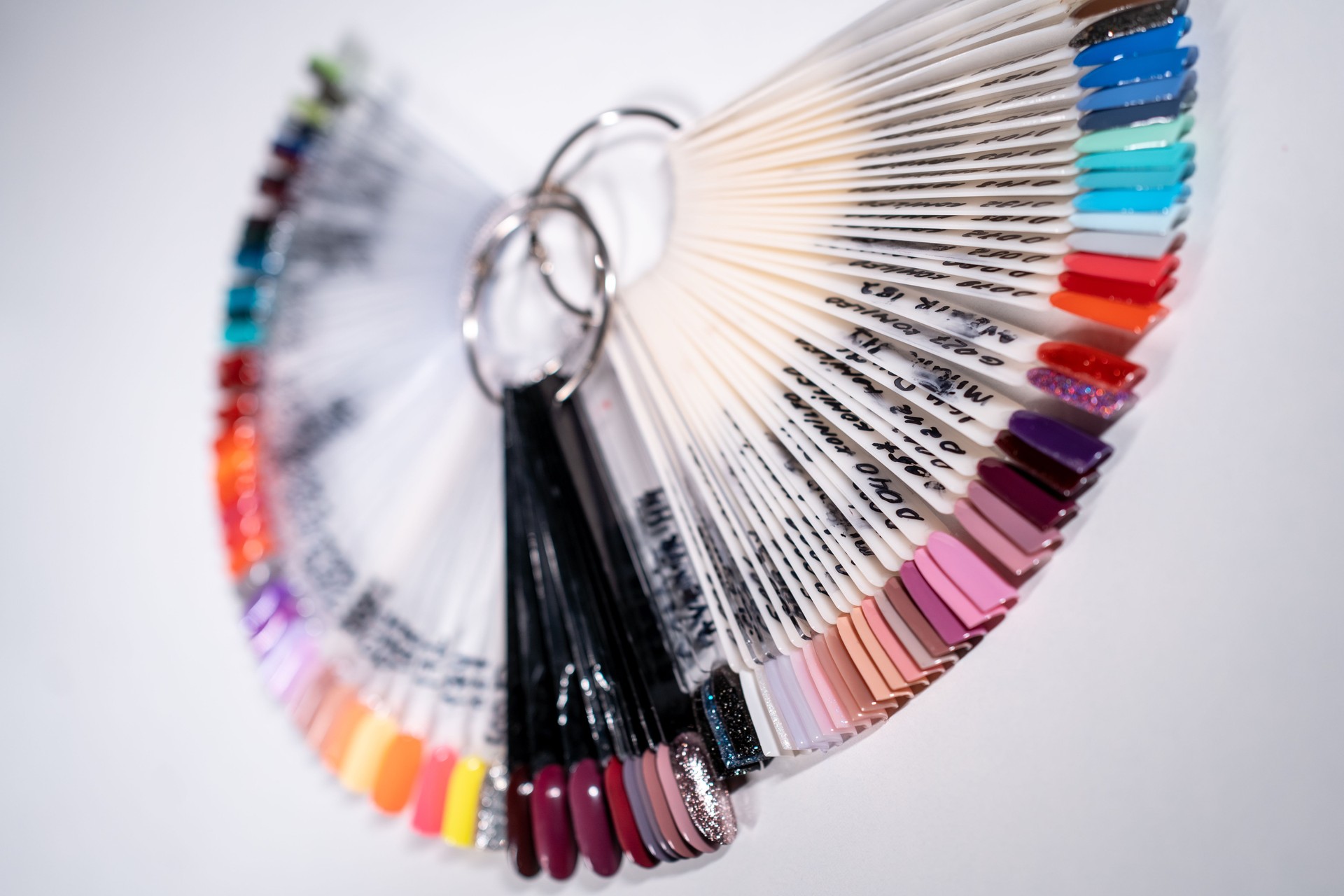 manicure artist making nail polish procedure with color laquer palette